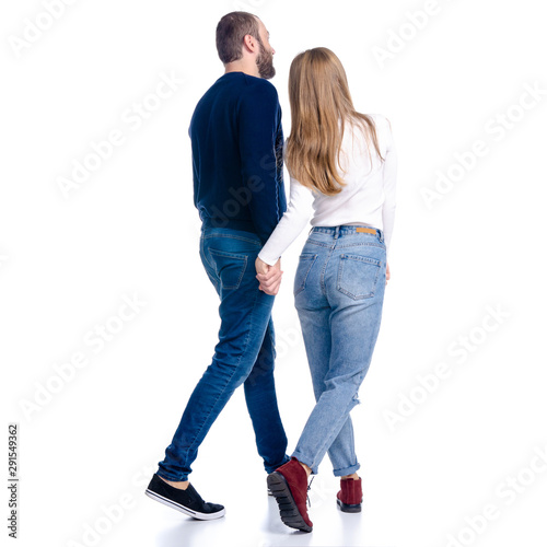 Young couple woman and man walking goes looking on white background isolation, rear view