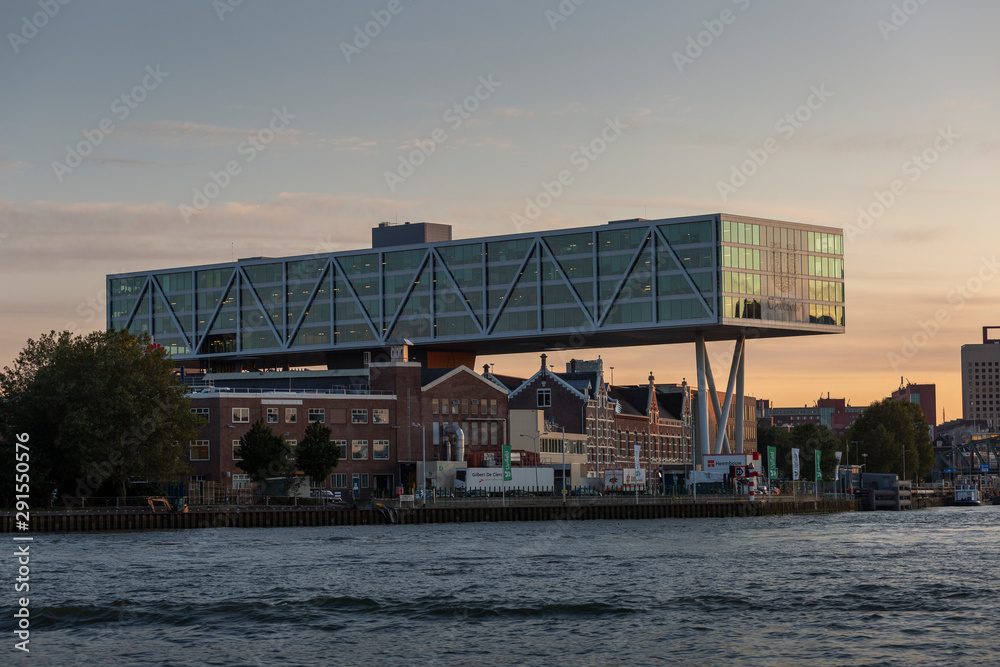 Unilever modern office building build over former traditional homes and offices with the modern city in the background at golden hour sunset Unilever modern office building build over former traditional homes and offices with the modern city in the background at golden hour sunset