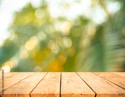 Real wood table top texture on blur fresh green garden background