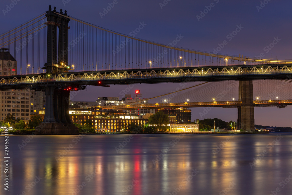 Brooklyn and Manhattan Bridges from East river at night with long exposure