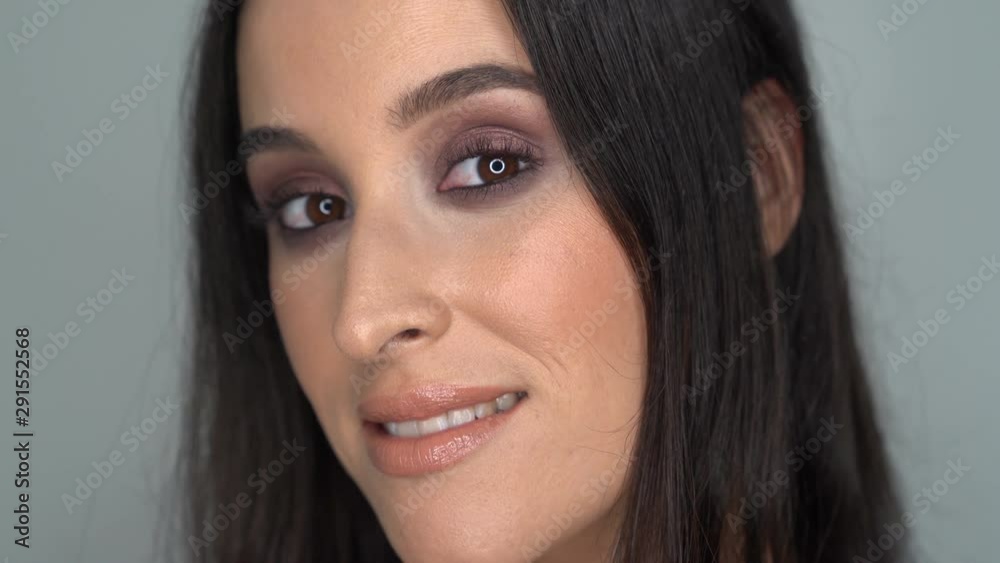 Beautiful Woman with make up posing looking the camera Beautiful Woman with make up posing looking the camera