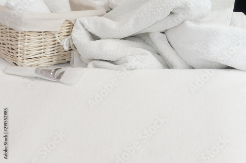 Beauty studio background. White towel, basket and cream. Body and face care