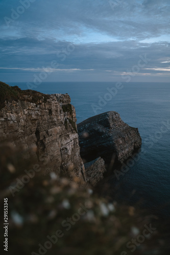 Blue hour before sunrise on the impressive cliffs of Cape Vidio in Asturias photo