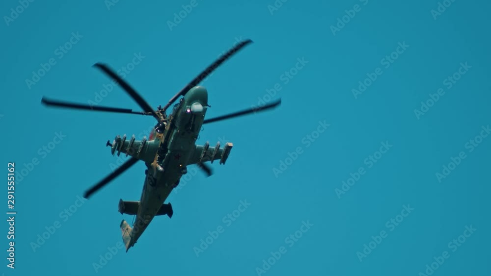 An army green camouflage coloring helicopter flying in the sky - gaining speed flying up An army green camouflage coloring helicopter flying in the sky - gaining speed flying up