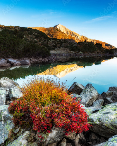 Morning sunrise view of the Ribno (fish) Banderishko (Banderitsa) lake and Vihren peak reflection in Pirin National Park, Bulgaria photo