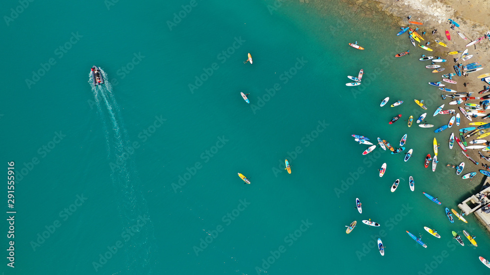 Aerial top down photo of Stand Up Paddle or SUP surfers in tropical exotic lake