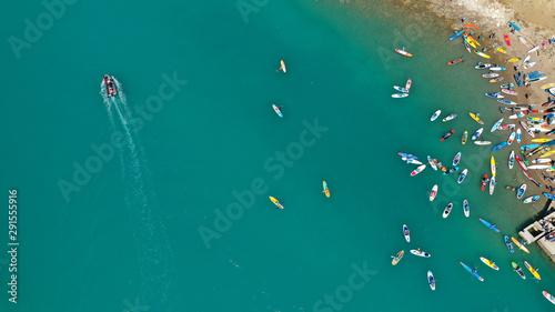 Aerial top down photo of Stand Up Paddle or SUP surfers in tropical exotic lake