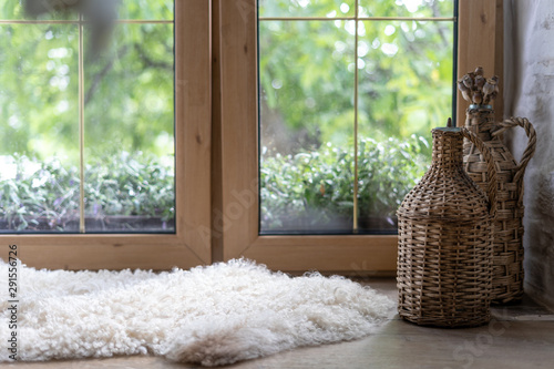 Sheepskin rug and home decor on wooden windowsill