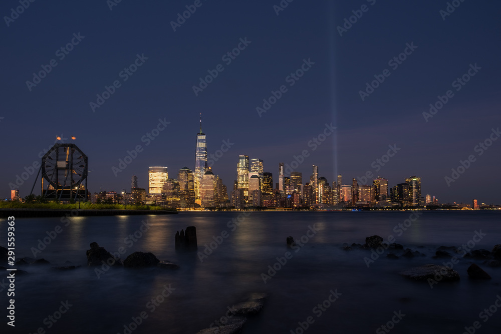 Lower Manhattan skyline with boat and ferry on Hudson river view from Liberty State Park in late summer