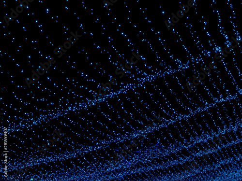 Blue lights pattern for design. New Year s garland. Waves of stars copy space.