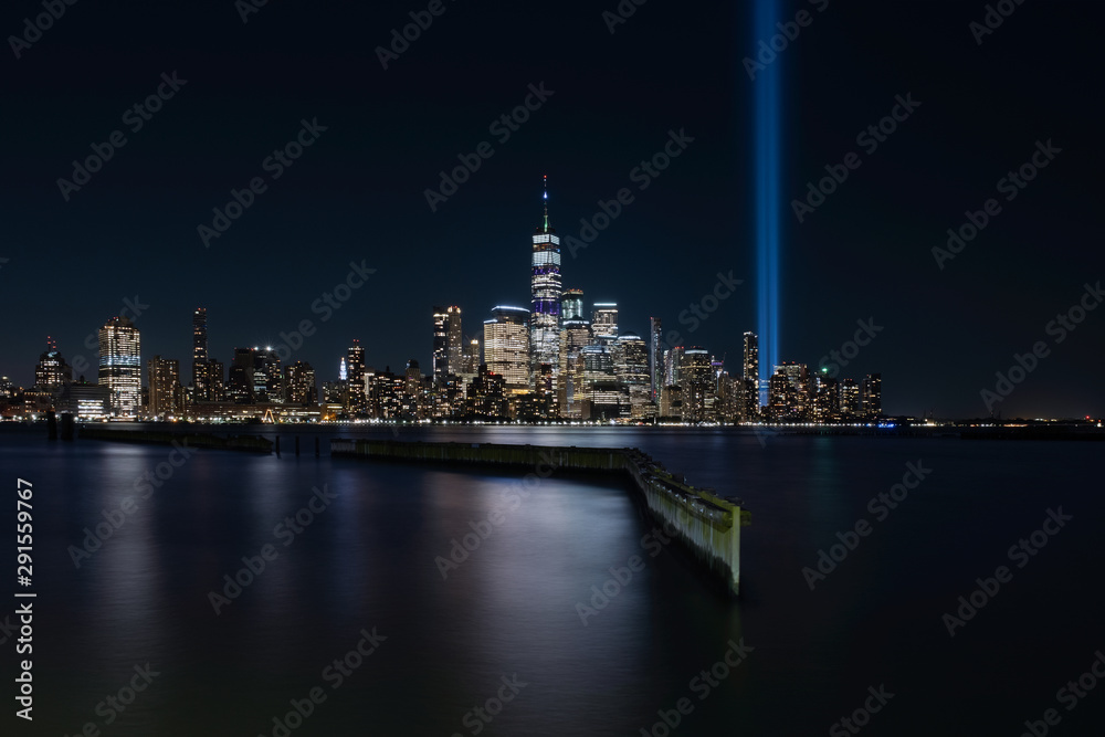 Jersey City, NJ - USA - Aug 30 2019: The 9/11 Tribute in Lights temporary monument in lower Manhattan New York City view from New Jersey