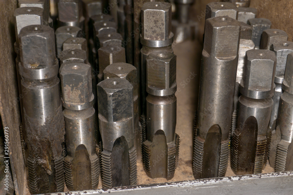 A tapping tap lies in a workshop in a warehouse. A tapping tap lies in a workshop in a warehouse.