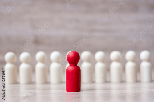 red leader businessman with crowd of wooden men. leadership  business  team  teamwork and Human resource management concept