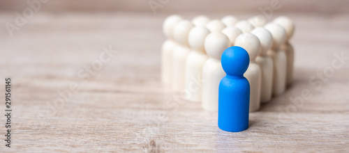 blue leader businessman with crowd of wooden men. leadership, business, team, teamwork and Human resource management concept