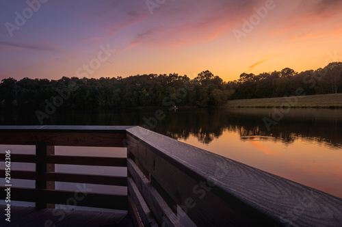 Sunset by the lake seen from a wood deck in the end of summer