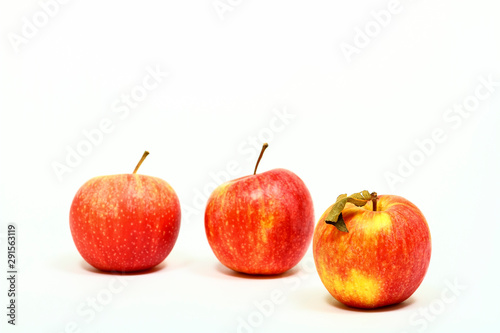 Three red eating apples isolated on a white background with space for copy