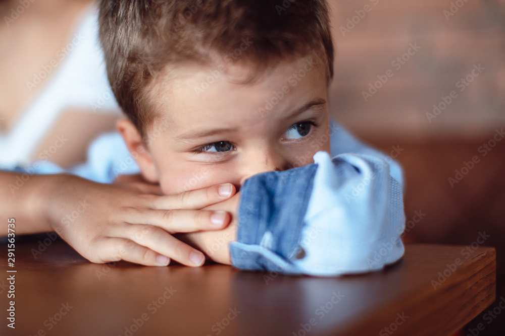 Little boy sitting worried, sad. Human expressions, body language Little boy sitting worried, sad. Human expressions, body language