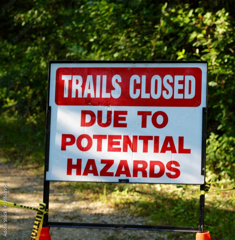 A close view of the red and white trails closed sign.
