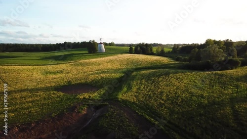 Aerial shot windmill on a countryside landscape. Beautiful golden hour light. photo