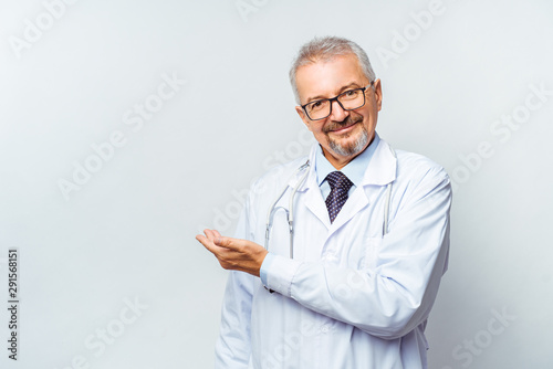 Bilde på lerret Cheerful mature doctor posing and smiling at camera, healthcare and medicine