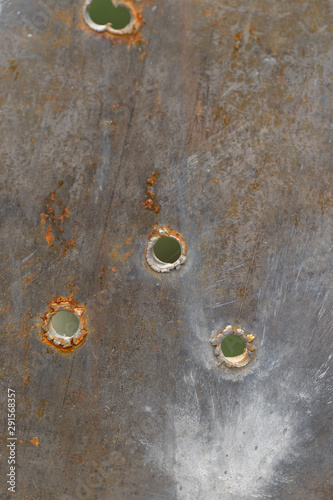 Metal texture with bullet holes. Close-up.