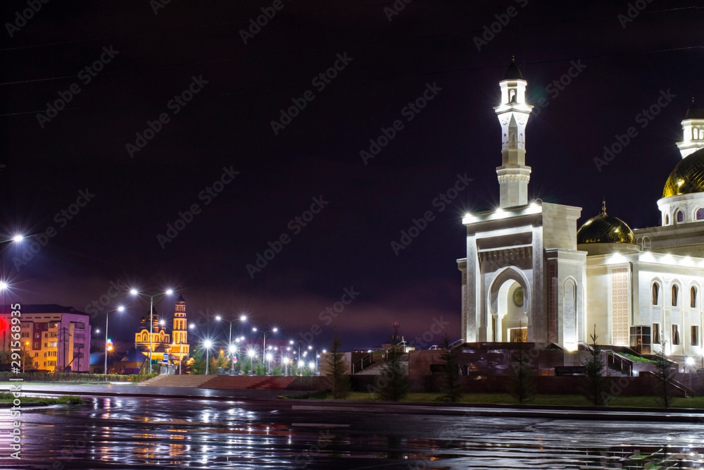 mosque at night after rain in light illumination