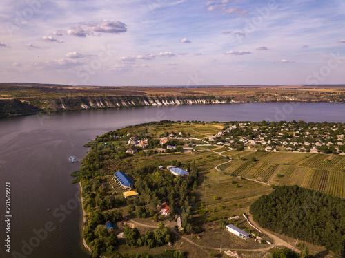 Arial view over the river and small village in autumn. Moldova republic of. Molovata village. River Dniester. photo