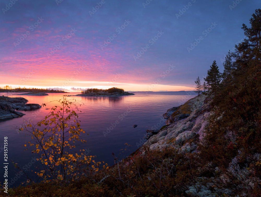Beautiful sunrise in the skerries of lake Ladoga. Karelia. Russia