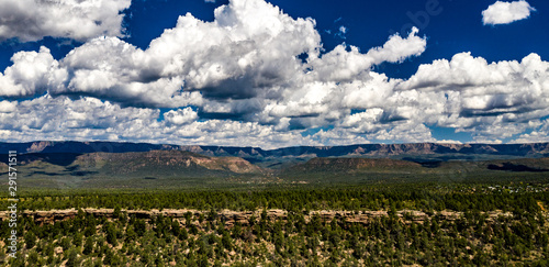 View of Mogollin Rim above the Houston Mesa near Payson, Arizona with blue sky, white clouds, pnderosa pines and cliffs photo