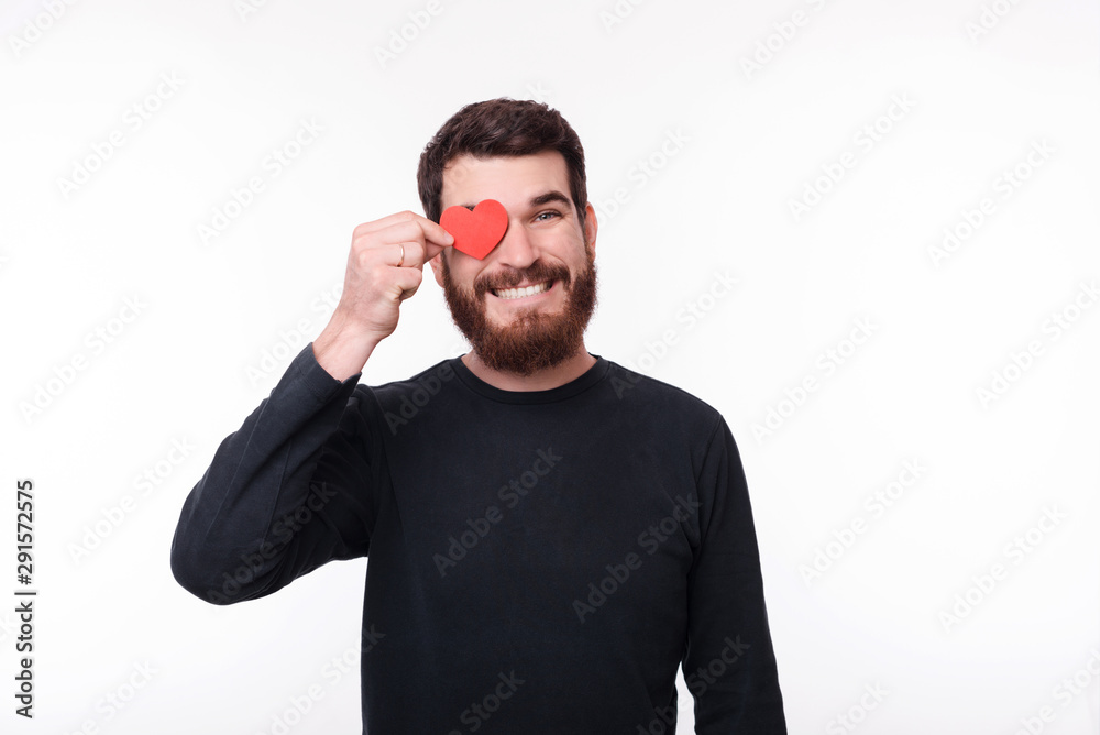 Photo of happy man holding heart shape over his eye Photo of happy man holding heart shape over his eye