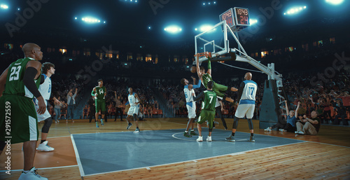 Basketball players on big professional arena during the game. Tense moment of the game. Celebration © haizon