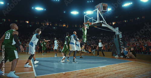 Basketball players on big professional arena during the game. Tense moment of the game. Celebration