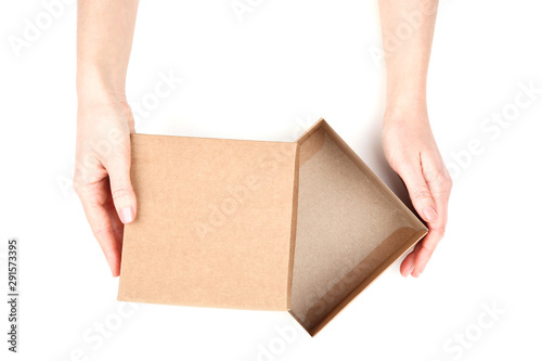 Female hands opening brown gift box on white background © 5second
