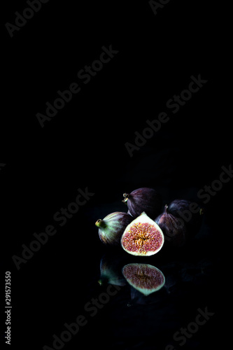 Seasonal berries - figs on the black background 