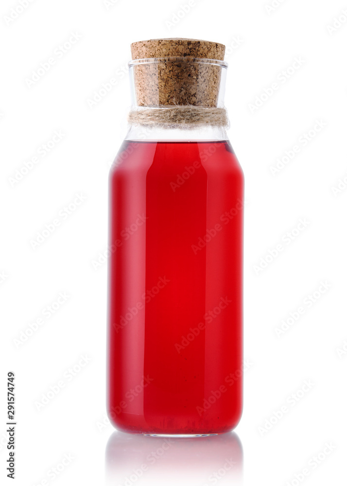 Red glass bottle of juice or compote on a white isolated background. Homemade lemonade carafe on a white background. Red glass bottle of juice or compote on a white isolated background. Homemade lemonade carafe on a white background.
