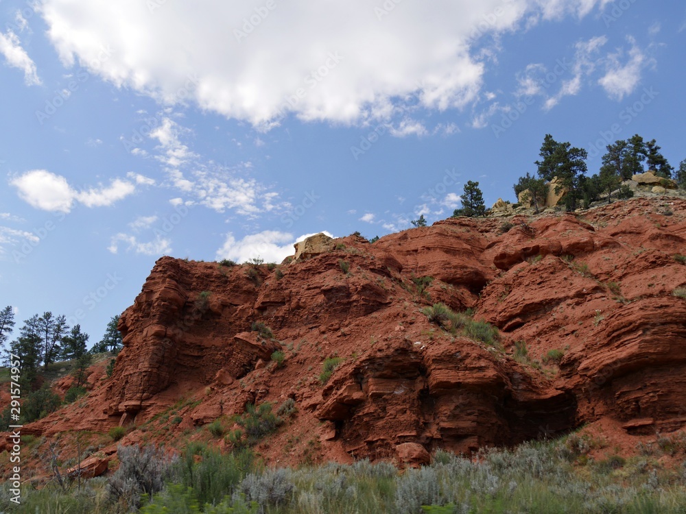 Close upward shot of red mountain cliffs near the Devils Tower in Wyoming. Close upward shot of red mountain cliffs near the Devils Tower in Wyoming.