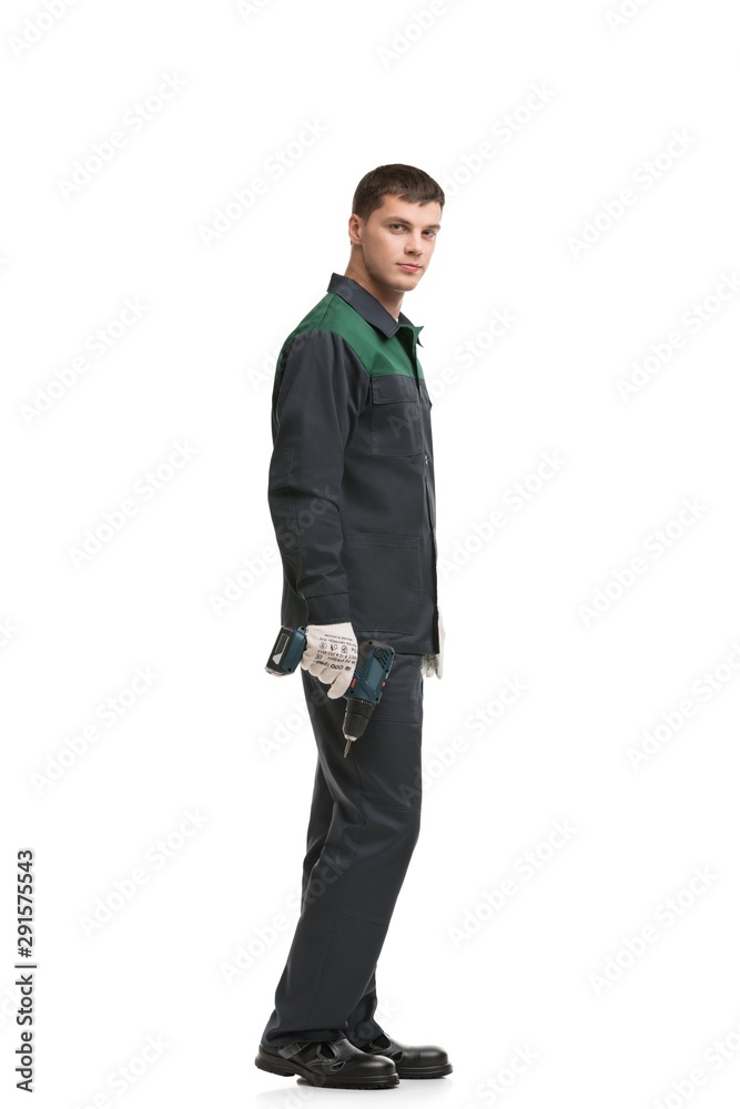 Man in working clothes with drill isolated view Man in working clothes with drill isolated view