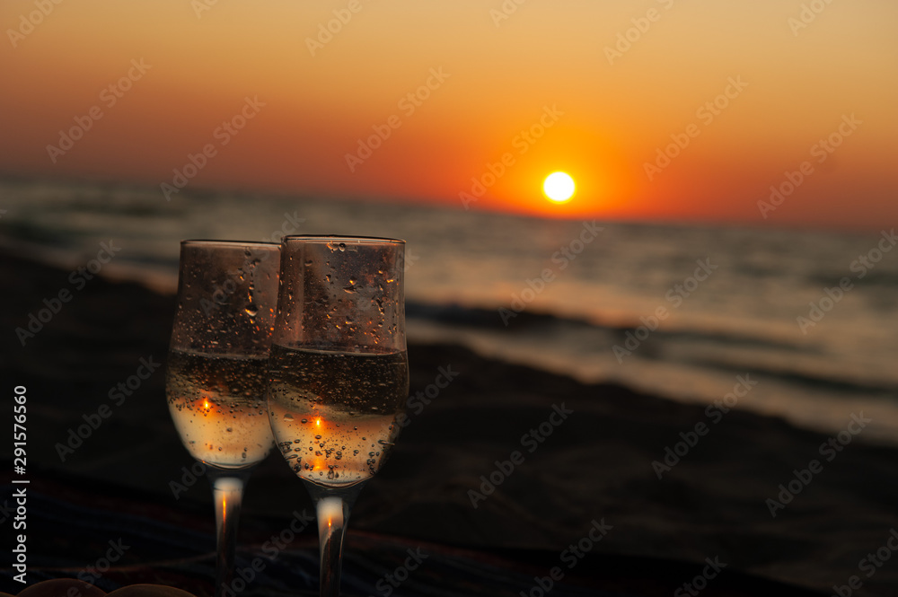 Glass of wine on sunrise, sunset background