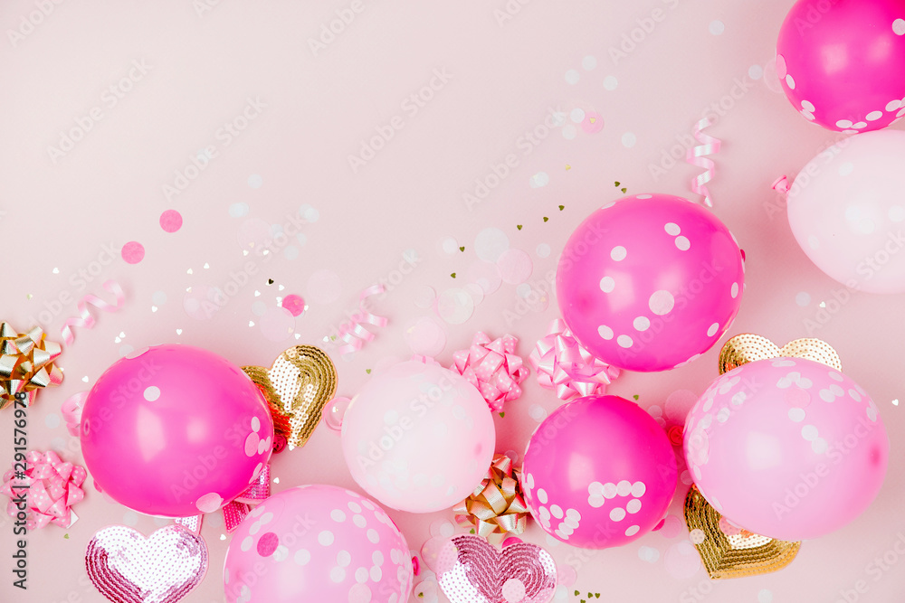 Pink balloons  with Confetti, bows and paper decorations. Birthday party concept theme. Flat lay, top view