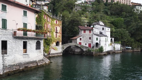 Nesso village with the bridge “Ponte della Civera” and the beautiful waterfall behind it