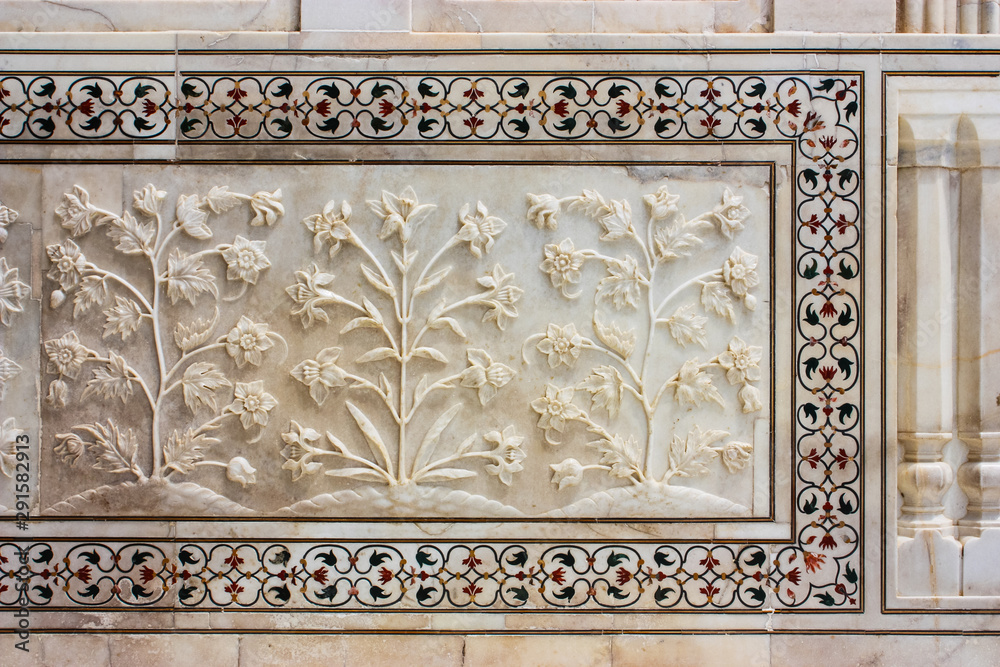 details of the bas-reliefs and floral inlays of the taj mahal in Agra, India