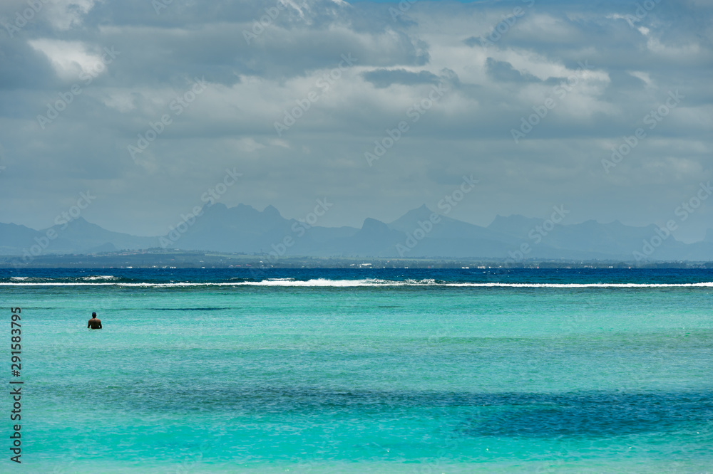 A man takes profit of the paradise beach of Pointe des Canonniers,  Indian Ocean, Mauritius island 