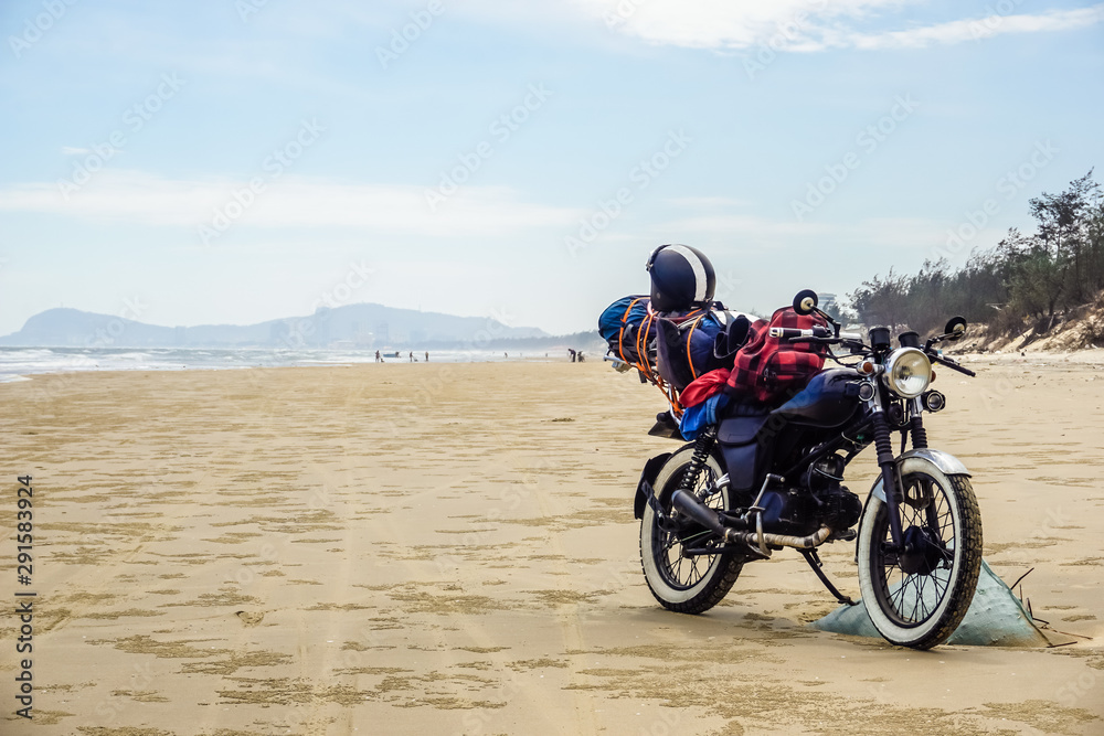 Obraz premium Motorcycle tour of Vietnam. Motorcycle on a wild beach in Vung Tau