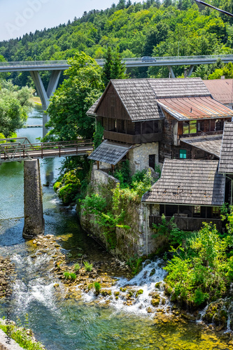 Beautiful Rastoke village on Korana river, near Slunj, Croatia, old bridge, waterfalls and green countryside landscape on sunny summer day