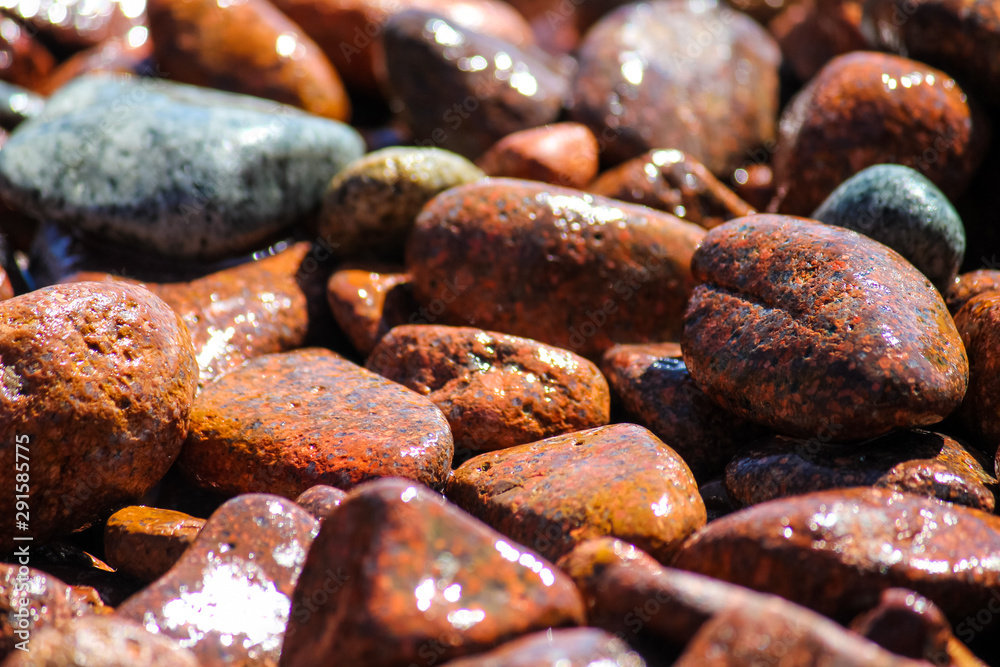 macro of some red pebbles on a beach on the côte d'azur in france macro of some red pebbles on a beach on the côte d'azur in france