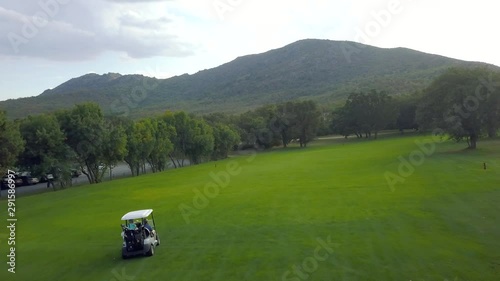 Boogies during a golf game. Flight over a golf course in a forest of ash trees. Escorial monastery photo