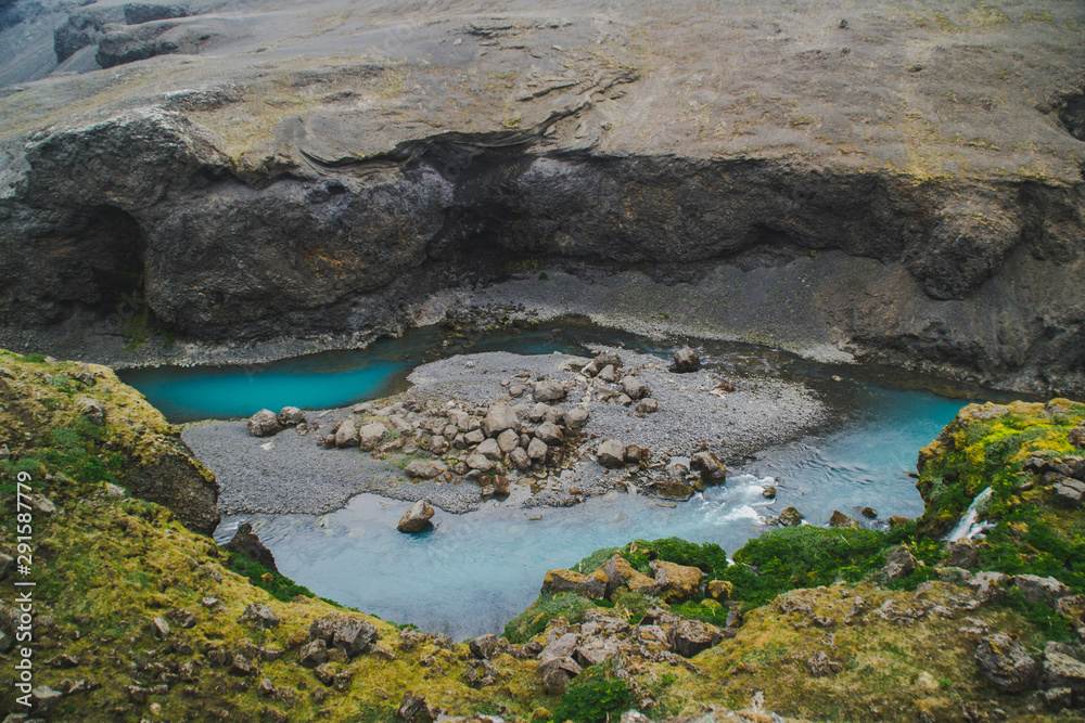 Scenic landscape view of incredible Sigoldugljufur canyon in highlands with turquoise river, Iceland. Volcanic landscape on background. Popular tourist attraction.