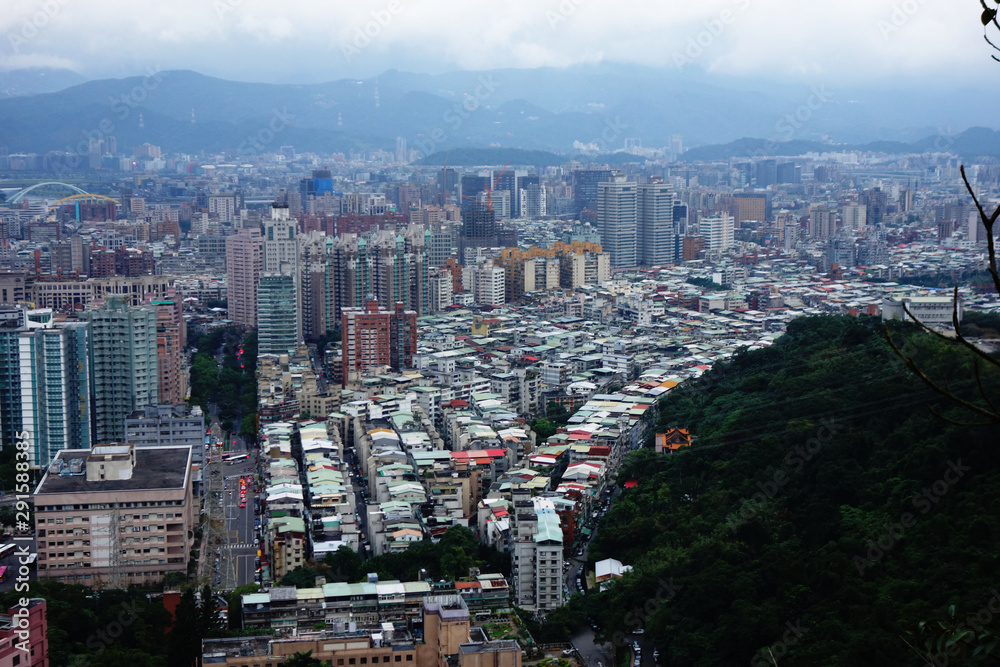cloudy Taipei with dense houses an buildings seen from  a hill 