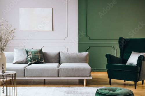Fototapeta Naklejka Na Ścianę i Meble -  Abstract oil painting on grey wall with moldings in contemporary living room interior with grey long couch