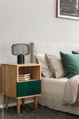 Canvastavla Beige and emerald bedroom design with modern lamp on wooden nightstand table